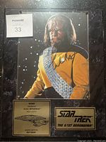 Full front view of Worf signed plaque with number plate, Star Trek TNG logo plate, and marbled backing.