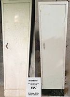Front view of two tall vintage white metal cabinets showing doors and handles.