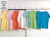 All 7 jerseys hanging from hangers shown in a row, displaying colors and sleeve cut.