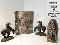 Photo of the End of the Trail bookends, Tom Mix book, and Native chief copper mold together against white background with lot information label.