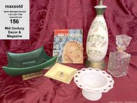 Overview photo of all items including green Everart bowl, vintage lamp, decanter, milk glass dish, and magazine