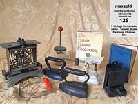 Wide view of all nine vintage homemaker kitchen items arranged on beige background.