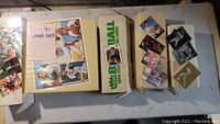 Binder labeled '91 Upper Deck with baseball cards, some missing, and two boxes with early 1990s football cards and loose cards.