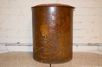 Front view of cylindrical wood ottoman with painted sailboat motif on the exterior