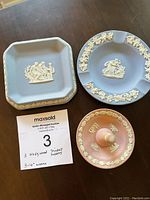 Three Wedgwood Jasperware trinket holders: blue square, blue round, and pink ring holder.