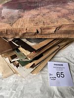 Stack showing thick pile of torn and yellowed scrapbook pages and loose clippings