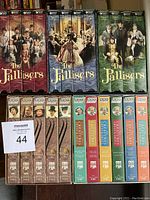 Front view of The Pallisers boxed VHS tapes series 1 to 3 and All Creatures Great & Small plus Dutchess of Duke Street VHS tapes lined up vertically.