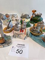 Photo showing all 8 figurines together arranged on a white surface with clear view of each piece.