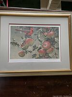 Full view of the framed and matted lithograph print showing the depiction of the cardinal and wild apples with the wooden gold trim frame.