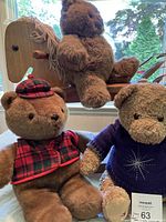 Photo showing the three stuffed bears and wooden rocking horse on window sill