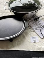 Photo showing the West Bend slow cooker with glass lid, ceramic insert, warming tray base, metal rack, and instruction manual.