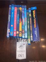 Blu-ray cases all stacked vertically showing spines and covers of various movies including Muppet Treasure Island, Back to the Future, Beauty and the Beast, and others