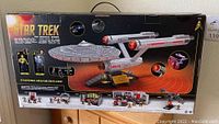 Box rear showing the Star Trek USS Enterprise Mega Bloks set including micro action figures of Kirk and Spock, and multiple small builds depicting scenes from the show.