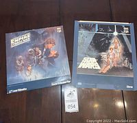 Both Star Wars and The Empire Strikes Back Laser Videodisc covers shown side by side on a wooden surface.