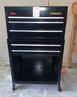 Front view of the Stanley black ball bearing tool chest with drawers closed in a garage setting.