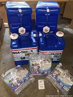 Four blue plastic Aqua-Tainer containers, 7-gallon capacity, and three packages of clear collapsible Water Storage Cubes, 5.3 gallons