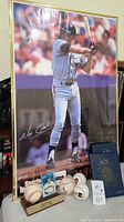 Photo showing Will Clark poster framed, signed baseball on display with card albums and other memorabilia at the base
