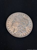 Obverse side of the 1900 Morgan Silver Dollar showing Lady Liberty and date 1900.