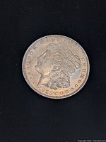 Front-facing view of the 1921 Morgan Silver Dollar showing Lady Liberty's profile and the year 1921.