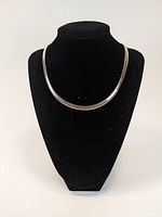 Front view of Italian sterling silver flat chain necklace displayed on black bust stand.