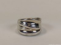 Front side view of wide band silver ring showing polished finish and diagonal ridge design.