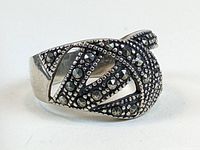 Close-up of the front and partial side view of the sterling silver ring showing marcasite stone detailing in geometric shapes.