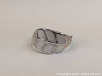 Front view showing the leaf design with mother of pearl inlays and sterling silver framing.