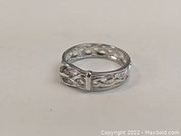 Front and side view of sterling silver ring with belt design showing the buckle detail and woven pattern.
