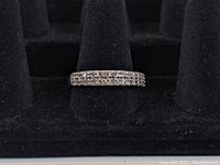 Front view of sterling silver ring showing double rows of clear stones set in the band.