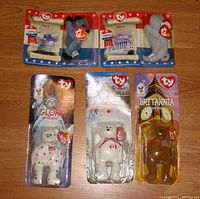 Photo showing five sealed Ty Baby Beanie plush toys from 1999 and 2000 including Lefty the Donkey, Righty the Elephant, Britannia, Maple, and Glory bears.