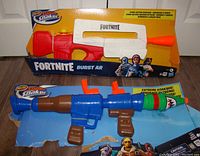 Photo showing the Fortnite Burst AR Nerf Super Soaker in its original box with white, red, and orange colors.