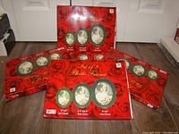 Five boxed sets of picture frames visible on floor. Each box states the sizes included: 2x3, 3.5x2.5, and 4x6 inches. Front packaging shows green oval frames with vintage photo of child.