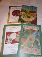 Two colorful booklet cover images: one Christmas themed storybook and one Folk Songs booklet with mailing advertisement.