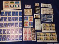 A broad view of various Canadian vintage stamps including blocks, partial sheets and individual stamps with visible denominations and designs.