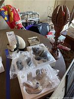 Three animal sculptures, carved wood lamp, and vintage shaver on table, including a panda sculpture note, and original packaging.