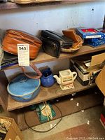 Shelves containing wallets, ceramic items, and boxed collectible ornaments