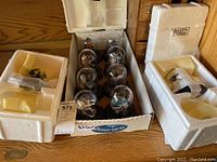 Overall view of all 10 Star Trek limited edition displays in original or protective packaging box showing glass domes and bases.