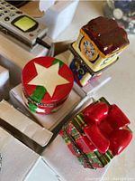 Photo of three colorful trinket boxes showing varied shapes and festive and novelty designs.