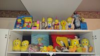 Wide view showing multiple Tweety Bird figurines, plush toys, and cushions on shelves