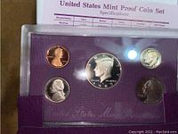 Close-up image of the 1989 US Mint Proof Coin Set showing 5 proof coins in purple holder with a specifications sheet behind.
