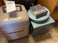 Bell and Howell carrying case with film splicer box and metal box of film.