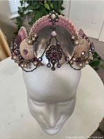 Front view of the handmade mermaid seashell crown displayed on a white foam head showing detailed arrangement of shells, beads, and decorative chains.