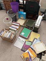 Photo showing Omnitech OT-535BK shredder, wastebaskets, briefcase, folders, and various office supplies on floor.