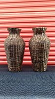 Pair of dark brown wicker floor vases side by side showing front view, shape, and size.