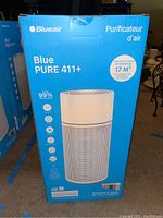Photo of Blueair Blue PURE 411+ air purifier box showing front view with model name and features.
