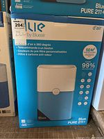 Front of Blueair Blue PURE 211+ air purifier box showing product image and key features in blue and white packaging.