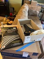 Photo showing Yokozuna Reaction Cable System in original sealed packaging along with the boxed bicycle seat.