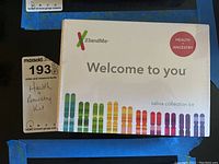 Front view of 23andMe Health and Ancestry saliva collection kit box showing branding and colorful chromosome design.