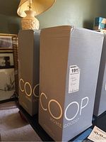 Two boxed COOP Home Goods pillows, gray tall packaging with COOP Home Goods branding.