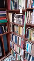 Bookshelves filled with various books including some history titles showing wear and dust jackets.
